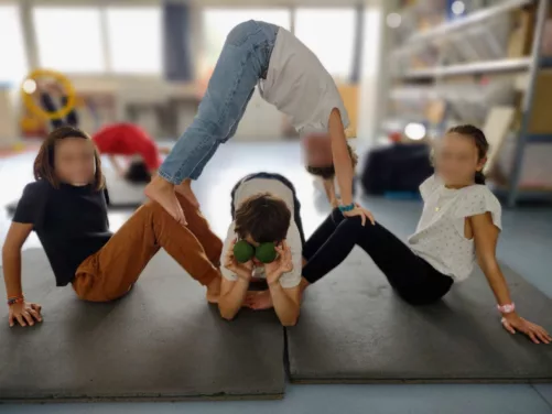 Atelier Cirque en périscolaire : exercice d'acroportés entre 4 enfants à Notre-Dame-de-Bon-Port